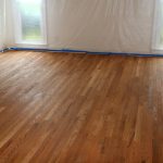 A room with hardwood floors being refinished.