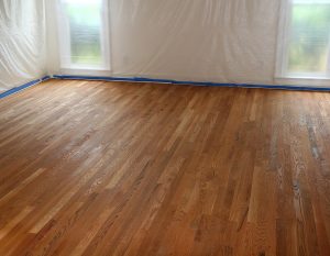 A room with hardwood floors being refinished.