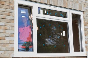 Construction Worker Installing New Windows In House